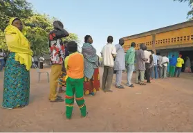  ?? Issouf Sanogo / AFP / Getty Images ?? Voters line up to cast ballots in Burkina Faso’s presidenti­al and legislativ­e elections at a polling station in the capital of Ouagadougo­u.