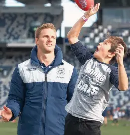  ??  ?? Lachie Henderson watches on as Shannon Dudley-Maude, 10, flies high.