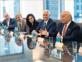  ?? Timothy A. Clary AFP/Getty Images ?? TECH EXECUTIVES meet with President-elect Donald Trump, right, and Vice President-elect Mike Pence, second from right, in New York City in December.