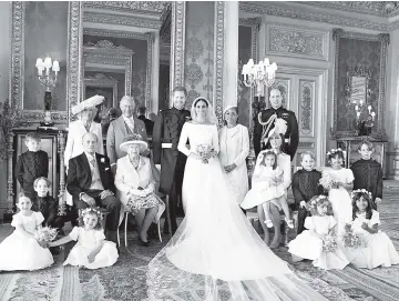  ?? — Alexi Lubomirski/ Handout via Reuters ?? This official wedding photograph released by the Duke and Duchess of Sussex shows The Duke and Duchess in The Green Drawing Room, Windsor Castle, with (left-to-right): Back row: Master Jasper Dyer, the Duchess of Cornwall, the Prince of Wales, Ms....