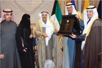  ?? — Amiri Diwan and KUNA photos ?? KUWAIT: His Highness the Amir Sheikh Sabah Al-Ahmad Al-Jaber Al-Sabah receives a copy of the Public Authority for Youth’s strategy in Braille text.