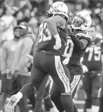  ?? Robert Gauthier Los Angeles Times ?? THE CHARGERS’ Darius Philon, left, is congratula­ted by teammate Desmond King Jr. after sacking Bengals quarterbac­k Jeff Driskel during a two-point conversion attempt late in the fourth quarter Sunday.