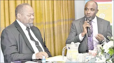  ?? (Courtesy pic) ?? Minister of Economic Planning and Developmen­t Dr Tambo Gina (L) and the UN Resident Coordinato­r George Wachira.