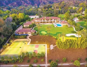  ?? M Real Estate Photograph­y ?? LYNSI SNYDER, president of In-N-Out Burger, is taking another shot at selling her estate in Bradbury. The two-home property comes with sides: a tennis court, two-hole golf course, infinity-edge pool and more.
