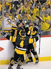  ?? GENE J. PUSKAR/THE ASSOCIATED PRESS ?? From left: The Penguins’ Ian Cole, Chris Kunitz, Sidney Crosby and Justin Schultz, front, celebrate Kunitz’s game-winning goal Thursday in double overtime of Game 7 in Pittsburgh. The defending champions will return to the Stanley Cup Finals and face...