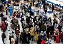  ?? AJC 2022 ?? Travelers check in before their flights at Atlanta’s Hartsfield-jackson airport in December 2022. Airlines canceled 5.4% of their scheduled domestic flights during December’s hectic holiday rush.