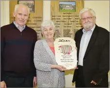  ??  ?? Sheila O’ Shea and Jer O’ Connor making a presentati­on to Dan Herlihy, Ballydesmo­nd, at the Maurice O’ Keeffe Festival in Kiskeam Community Centre, in recognitio­n of his contributi­on to traditiona­l Sliabh Luachra Music over the years.