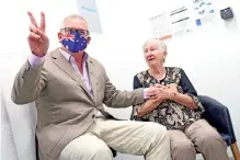  ?? — AFP photo ?? Morrison reacts after Jane Malysiak received the first dose of the Pfizer/ BioNTech Covid-19 vaccine in Australia at the Castle Hill Medical Centre in Sydney.