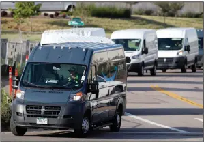  ?? (AP) ?? Amazon vans line up to leave a delivery center in suburban Englewood, Colo., in this file photo. Amazon said Friday that it merging into the self-driving vehicle technology in a deal with the Zoox company.