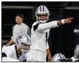  ?? AP/TONY GUTIERREZ ?? Dallas Cowboys quarterbac­k Dak Prescott gives instructio­ns at the line of scrimmage during a workout earlier this month in Frisco, Texas.