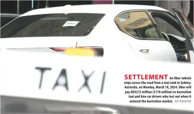  ?? AP PHOTO ?? An Uber vehicle stops across the road from a taxi rank in Sydney, Australia, on Monday, March 18, 2024. Uber will pay AU$272 million ($178 million) to Australian taxi and hire car drivers who lost out when it entered the Australian market.