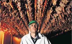  ?? Photos by Michael Macor / The Chronicle ?? Above: David Pitman stands inside his family’s state-of-the-art processing plant in Fresno County. Top: One-month-old free-range chicks gather to drink water.