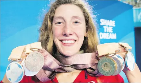  ?? RYAN REMIORZ/THE CANADIAN PRESS ?? Taylor Ruck holds her eight swimming medals at the Commonweal­th Games last week in Gold Coast, Australia. The 17-year-old swimmer was one of Canada’s bright spots, winning one of the country’s 15 gold medals, well below the 31 collected four years ago.