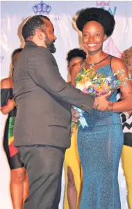  ??  ?? David Tulloch of sponsor Phoenix Theatre presents a bouquet to Shanique Salmon (Miss Hilda’s Wine Jelly).