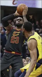  ?? Tony Dejak ?? The Associated Press Cleveland Cavaliers star Lebron James (23) shoots over Indiana Pacers guard Thaddeus Young (21) on Wednesday in Cleveland.