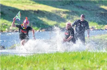  ?? PICTURE: HENK KRUGER ?? STRONG RUNNING REQUIRED: Beyers Rossouw, left, Hannes Malan, centre, and Ferdinand Rabie, right, running through the Berg River in Paarl while testing the course for tomorrow’s StrongmanR­un. The Fisherman’s Friend StrongmanR­un is the world’s biggest...