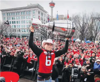  ?? JEFF McINTOSH, THE CANADIAN PRESS ?? Stampeders punter Rob Maver hoists the trophy during celebratio­ns at city hall in Calgary on Tuesday as more than 6,000 fans soaked it all in.