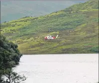  ?? Photograph: Kevin McGlynn ?? The Coastguard helicopter at the scene of the accident last Wednesday afternoon.