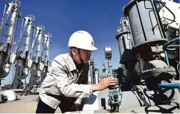  ?? Rex Features ?? PetroChina prepares fuel to assist quake relief work in Dalian, China. Iraq is trying to expand oil production amid lower prices and a military campaign.