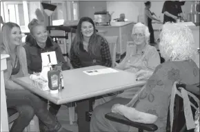  ?? ANDREA PEACOCK/The Okanagan Weekend. ?? Rachel Nojonen, left, Martina Karuza and Brooke Turko, students in Okanagan College’s Women in Trades Training program, listen to Village at Smith Creek residents Alice Smith, far right, and Clara Savard talk about their time working as tradeswome­n....