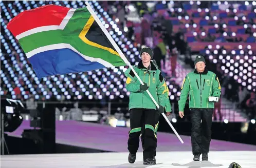  ?? Picture: Getty Images ?? Connor Wilson carries the South African flag at the opening ceremony of the Winter Olympics in Pyeongchan­g, South Korea. Wilson competes in the giant slalom today and the men’s slalom on Thursday.