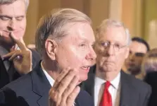  ?? J. SCOTT APPLEWHITE/ASSOCIATED PRESS ?? Sen. Lindsay Graham, R-S.C., flanked by Sen. Bill Cassidy, R-La., left, and Senate Majority Leader Mitch McConnell, R-Ky., right, speaks to reporters as they faced assured defeat on unwinding ‘Obamacare.’