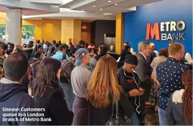  ??  ?? Unease: Customers queue in a London branch of Metro Bank