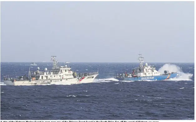  ?? REUTERS ?? A ship of the Vietnam Marine Guard is seen near one of the Chinese Coast Guard in the South China Sea off the coast of Vietnam.