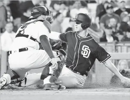  ?? Photograph­s by Wally Skalij Los Angeles Times ?? SAN DIEGO FIRST BASEMAN Wil Myers scores the game’s second run on a sacrifice fly by Ryan Schimpf, beating shortstop Corey Seager’s throw from shallow left field to catcher Yasmani Grandal in the first inning.