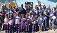  ??  ?? Minister of Education Ruel Reid (centre) joins volunteers and students to celebrate the opening of the Lloyd’s Basic School in St Thomas, built by Food For The Poor, Canada, and led by philanthro­pist Donette Chin-Loy Chang, wife of the late G. Raymond...