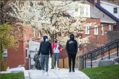  ??  ?? Tenth grader Angelo Murphy, left, and ninth grader Aaron Benton walk to Allderdice High School on Tuesday.