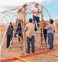  ?? COURTESY OF NMSU ?? Participan­ts in New Mexico State University’s Rural Agricultur­al Improvemen­t and Public Affairs Project build a hoop house to extend the growing season as part of the Pueblo Beginning Farmers and Ranchers program now expanded to 18 pueblos. In the...