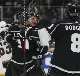  ?? ASHLEY LANDIS — THE ASSOCIATED PRESS ?? Kings center Blake Lizotte, center, celebrates with Trevor Lewis, left, and Drew Doughty after scoring a goal against Arizona in Tuesday night's game at Crypto.com Arena.