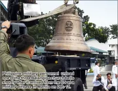  ??  ?? Philippine military personnel unload one of the three Balangiga church bells shortly after it arrived from the US at a military airbase in Manila on Dec 11.