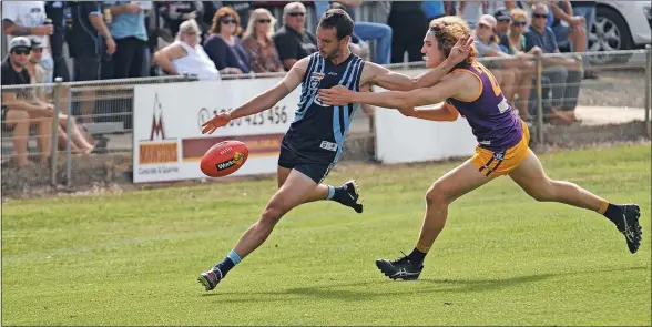  ?? Photos: Rohan Aldous ?? Under pressure: Tongala’s Jack Hammond goes to kick the ball while a Nathalia player tries to bring him down.