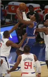  ?? BRAD PENNER - THE ASSOCIATED PRESS ?? New York Knicks shooting guard RJ Barrett (9) drives to the basket against LA Clippers center Serge Ibaka (9) and small forward Kawhi Leonard (2) during the first half of an NBA basketball game Sunday, Jan. 31, 2021, in New York.