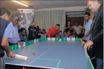  ??  ?? GOOD SPORTS: Bradlyn Stuurman from Sporting Chance teaches table cricket to excited pupils at Bel Porto School in Lansdowne, as sponsor Mike Greeff from Greeff Properties looks on.