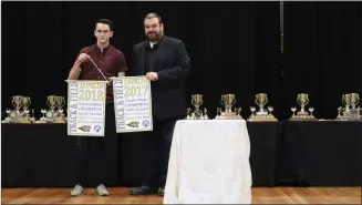  ?? Photo submitted to The McLeod River Post ?? The Holy Redeemer Awards Ceremony was on January 27 and celebrated excellence in academics, athletics, citizenshi­p, and fine arts. Here, teacher Brian Davison presents Justin Breault with the Provincial Championsh­ip Banner in Javelin. The last two years, Breault has smashed the provincial record in the event, and hopes to do it again this year.