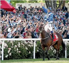  ?? GETTY IMAGES ?? Hugh Bowman salutes the sold-out Moonee Valley crowd following Winx’s third successive Cox Plate victory.