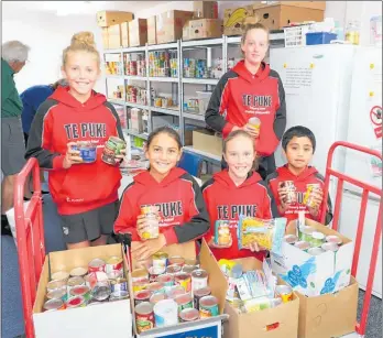  ??  ?? Te Puke Primary School ambassador­s delivered food and toiletries collected at the school to Te Puke Foodbank recently. Pictured are student ambassador­s Piper Rainford (rear) and, from left, Gracie Willis, Lily Rolleston, Danica Head and EJ Sigue. The ambassador­s also donated $295 to the NZME Special Children’s Christmas party.