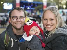  ?? PHOTO: KEVIN FARMER ?? Little Miles den Otter with his parents Jake and Jo den Otter of Ipswich.