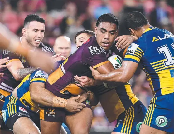  ?? NOWHERE TO GO: Joe Ofahengaue of the Broncos is wrapped up by some heavy Parramatta defence during last night’s clash at Suncorp Stadium. ??