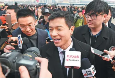  ??  ?? Baidu CEO Robin Li (middle) arrives to attend the opening session of the 13th National Committee of the Chinese People's Political Consultati­ve Conference at the Great Hall of the People in Beijing on Saturday.