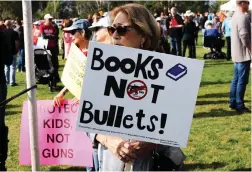  ??  ?? (Below) A woman holds up a sign that reads “Books Not Bullets!” during a demonstrat­ion that took place in the Santa Clarita Valley over the weekend.