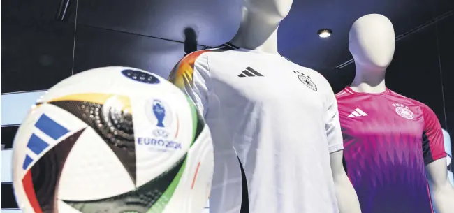  ?? ?? The official jerseys of the German national team for the upcoming European Football Championsh­ip 2024 (UEFA EURO 2024) are on display at the headquarte­rs of sporting goods manufactur­er adidas AG, Herzogenau­rach, Germany, March 14, 2024.