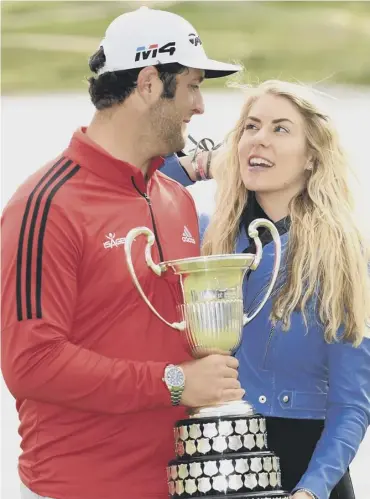  ??  ?? 0 World No 4 Jon Rahm celebrates winning on home soil in Spain with his girlfriend, Kelley Cahill.