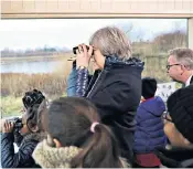  ??  ?? Schoolchil­dren at the London Wetland Centre gather for bird watching with Theresa May, the Prime Minister, and Michael Gove, the Secretary of State for the Environmen­t