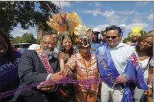  ?? PAUL CONNORS — BOSTON HERALD ?? Parade Grand Marshall and former city councilman David Yancey, left, Mayor Michelle Wu, center, and Caribbean Carnival president Shirley Shillingfo­rd, right, cut the ribbon for the start of the Caribbean Festival parade Saturday in Boston.