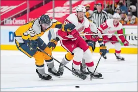  ?? PAUL SANCYA/AP PHOTO ?? Nashville Predators defenseman Ben Harpur (17) and Detroit Red Wings right wing Anthony Mantha (39) chase a loose puck in a game on April 6 in Detroit.