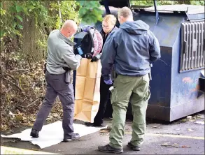  ?? Peter Hvizdak / Hearst Connecticu­t Media ?? New Haven police investigat­e the scene where an 8-month-old girl was found alive in a dumpster outside an apartment complex Monday at 575 Dixwell Ave. in New Haven. Here, a car seat is taken from the dumpster.